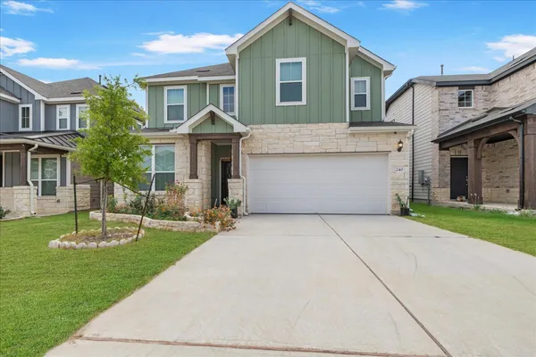 a front view of a house with a garden and plants