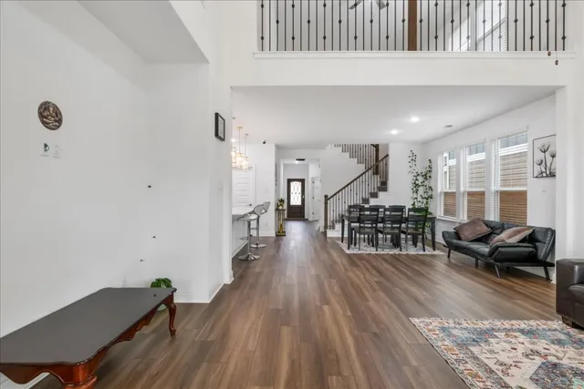 a living room with lots of furniture and wooden floor