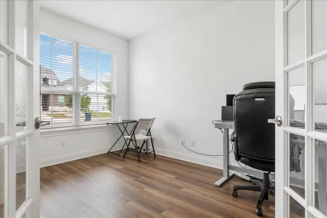 a view of a workspace with furniture and a window