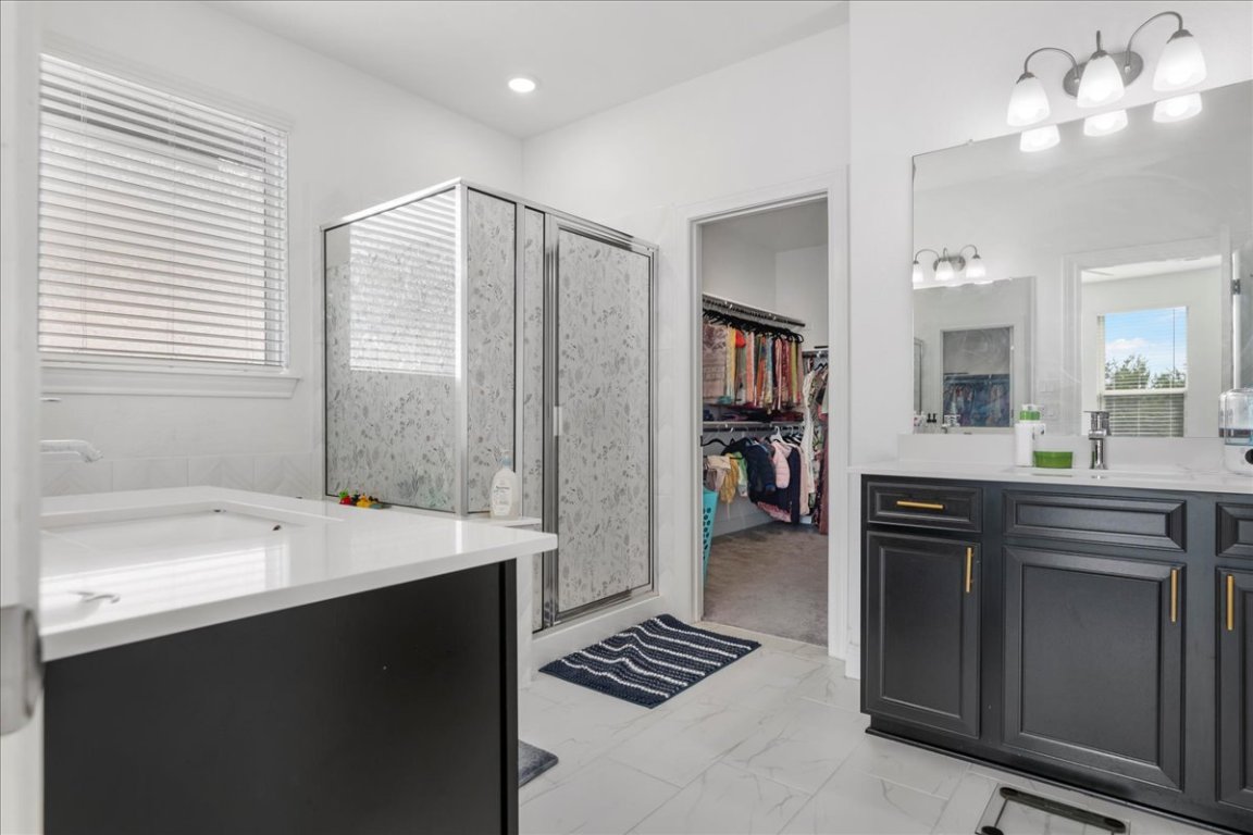 240 Inlet Lane Leander, TX 78641 - Photo 18 of 33 a bathroom with a sink and a mirror
