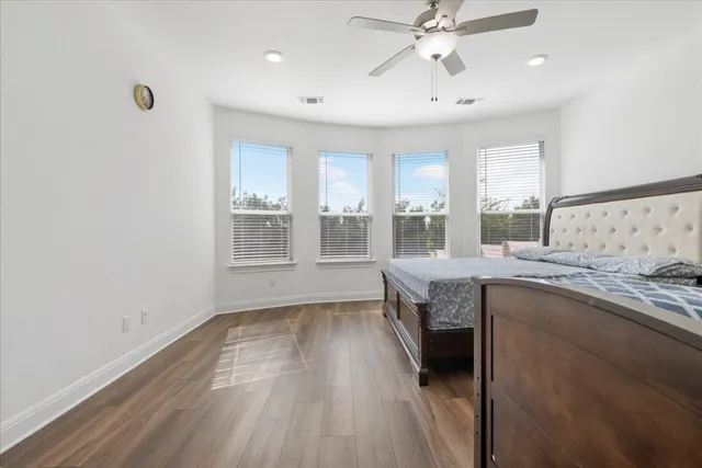 a kitchen with a sink and wooden floor