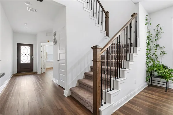 a view of entryway with wooden floor and stairs