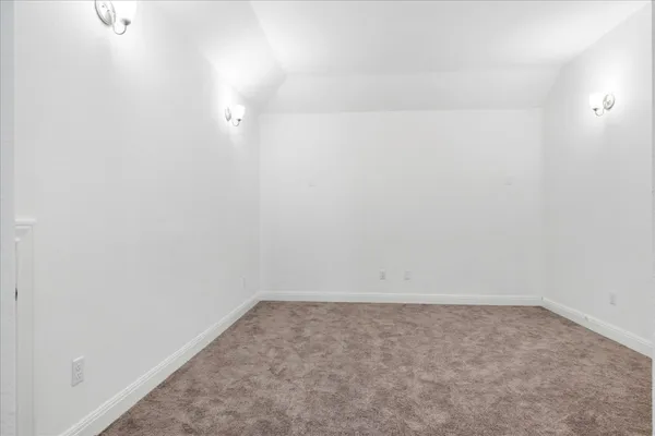 a view of a hallway with a chandelier fan