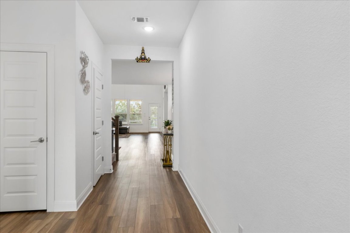 240 Inlet Lane Leander, TX 78641 - Photo 6 of 33 a view of a hallway with wooden floor