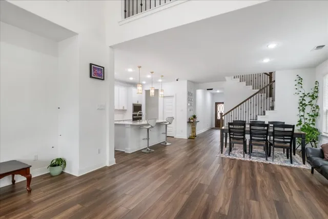 a dining room with furniture and wooden floor