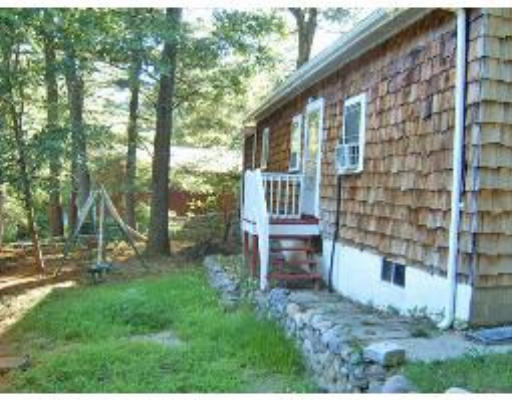 52-50 Summit Road Holbrook, MA 02343 - Photo 6 of 6 a backyard of a house with table and chairs