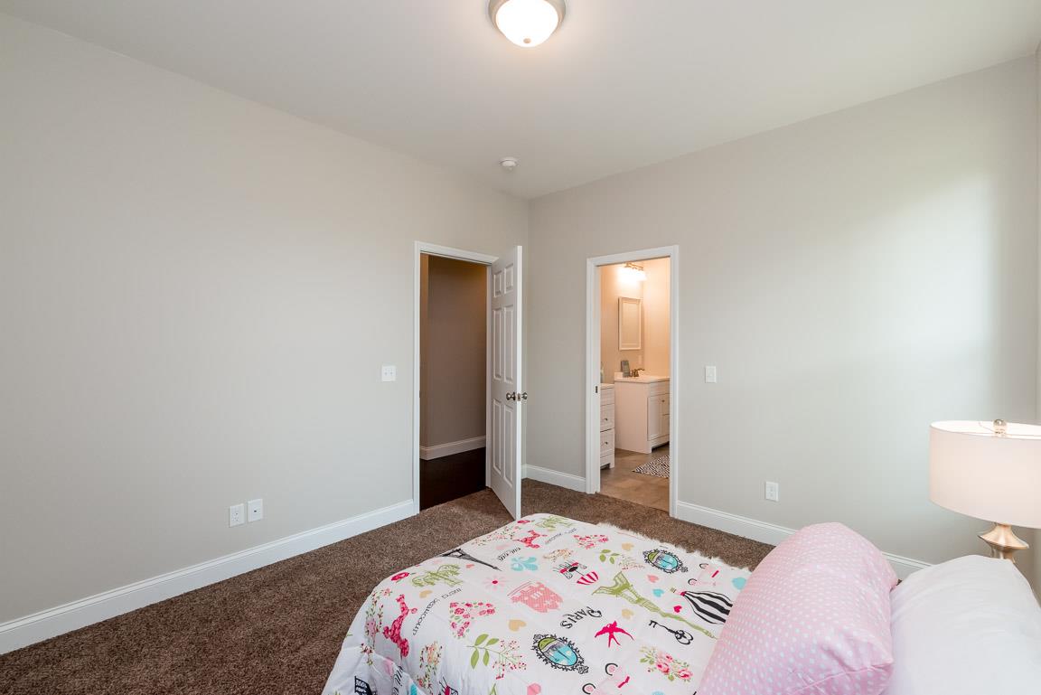 708 Ruby Way White Bluff, TN 37187 - Photo 16 of 30 a bedroom with a bed and a lamp with the table