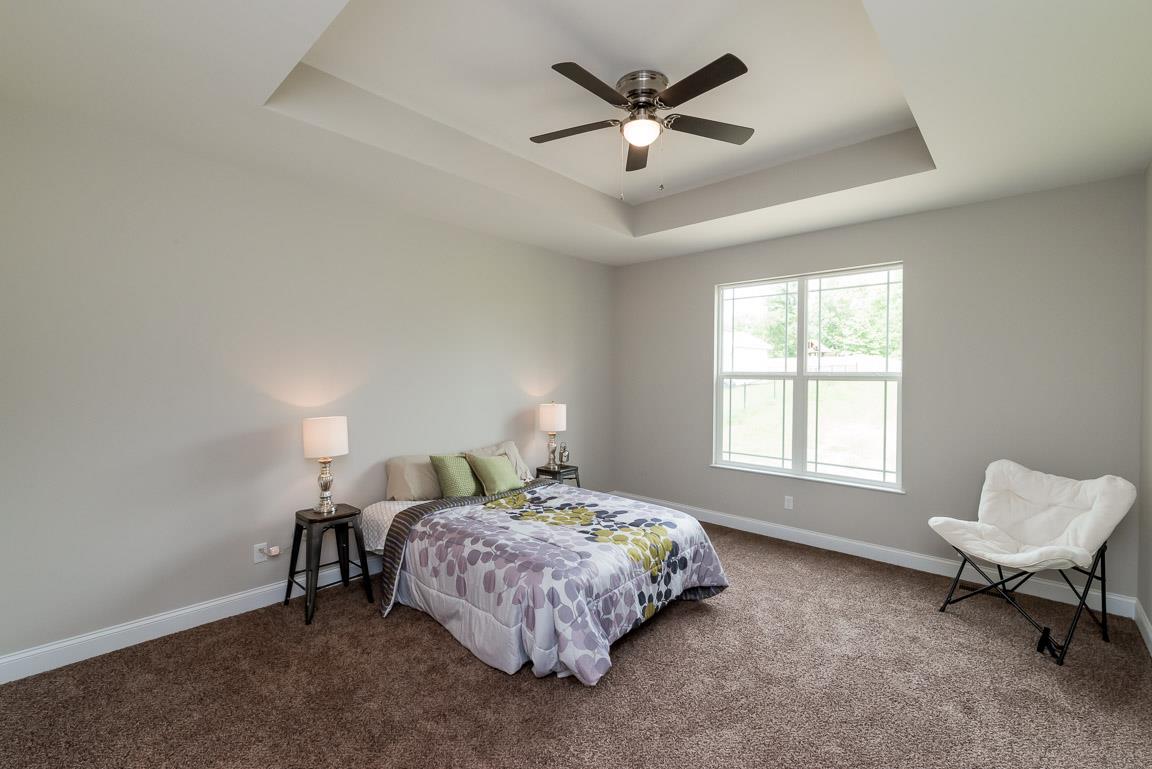 708 Ruby Way White Bluff, TN 37187 - Photo 19 of 30 a spacious bedroom with a bed painting on wall and a window