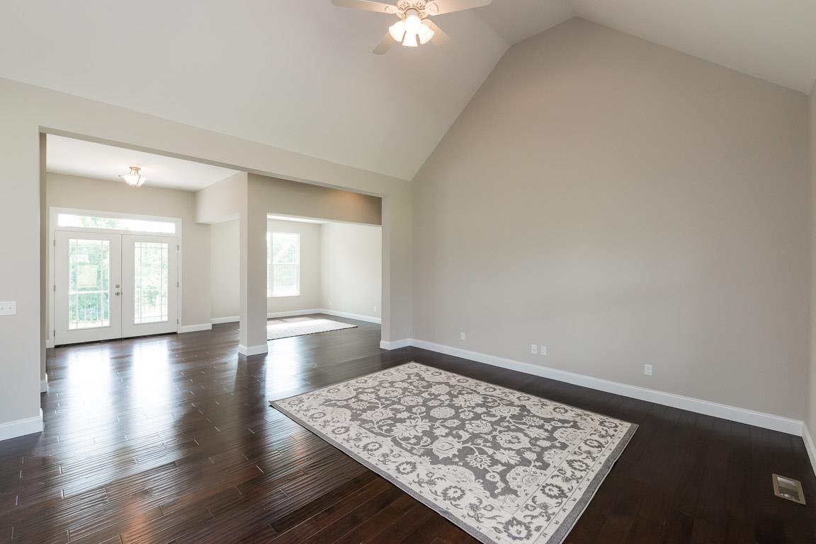 708 Ruby Way White Bluff, TN 37187 - Photo 2 of 30 an empty room with wooden floor and windows