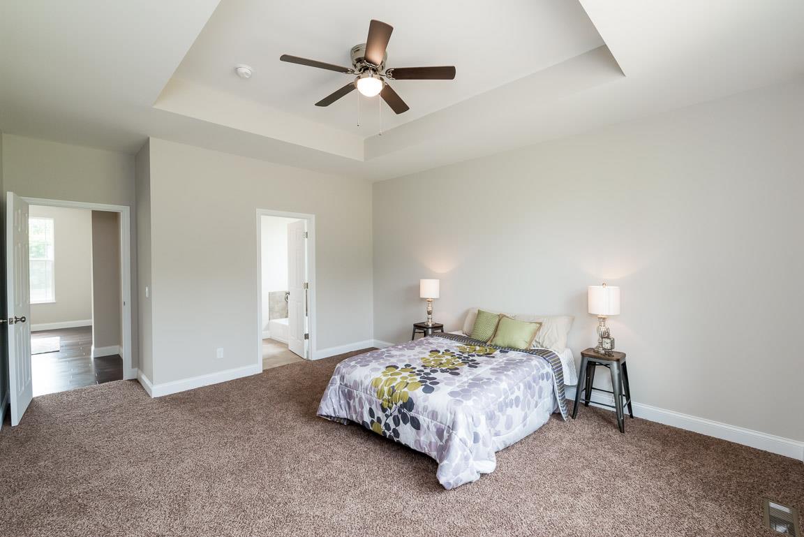 708 Ruby Way White Bluff, TN 37187 - Photo 22 of 30 a bedroom with a bed chandelier and a window