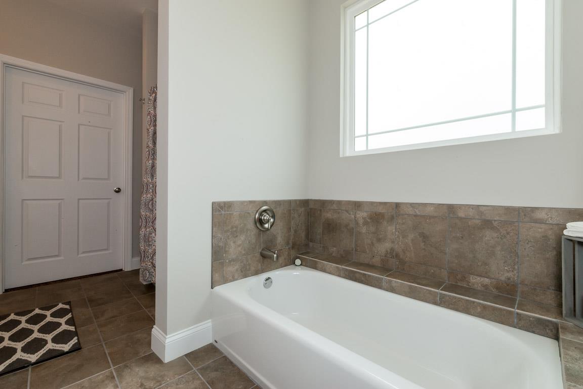 708 Ruby Way White Bluff, TN 37187 - Photo 26 of 30 a bathroom with a bathtub and a window
