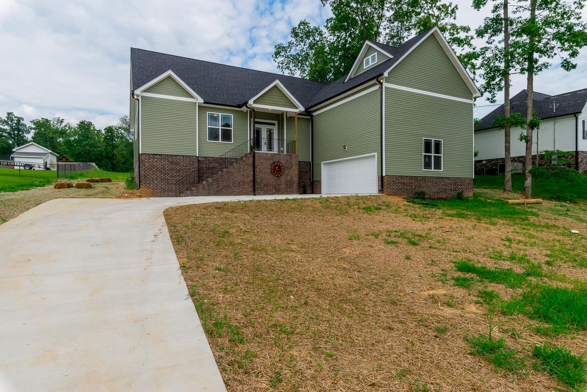 708 Ruby Way White Bluff, TN 37187 - Photo 4 of 30 a front view of a house with a yard and garage