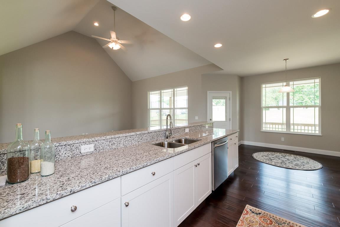 708 Ruby Way White Bluff, TN 37187 - Photo 6 of 30 a large kitchen with granite countertop a sink and cabinets