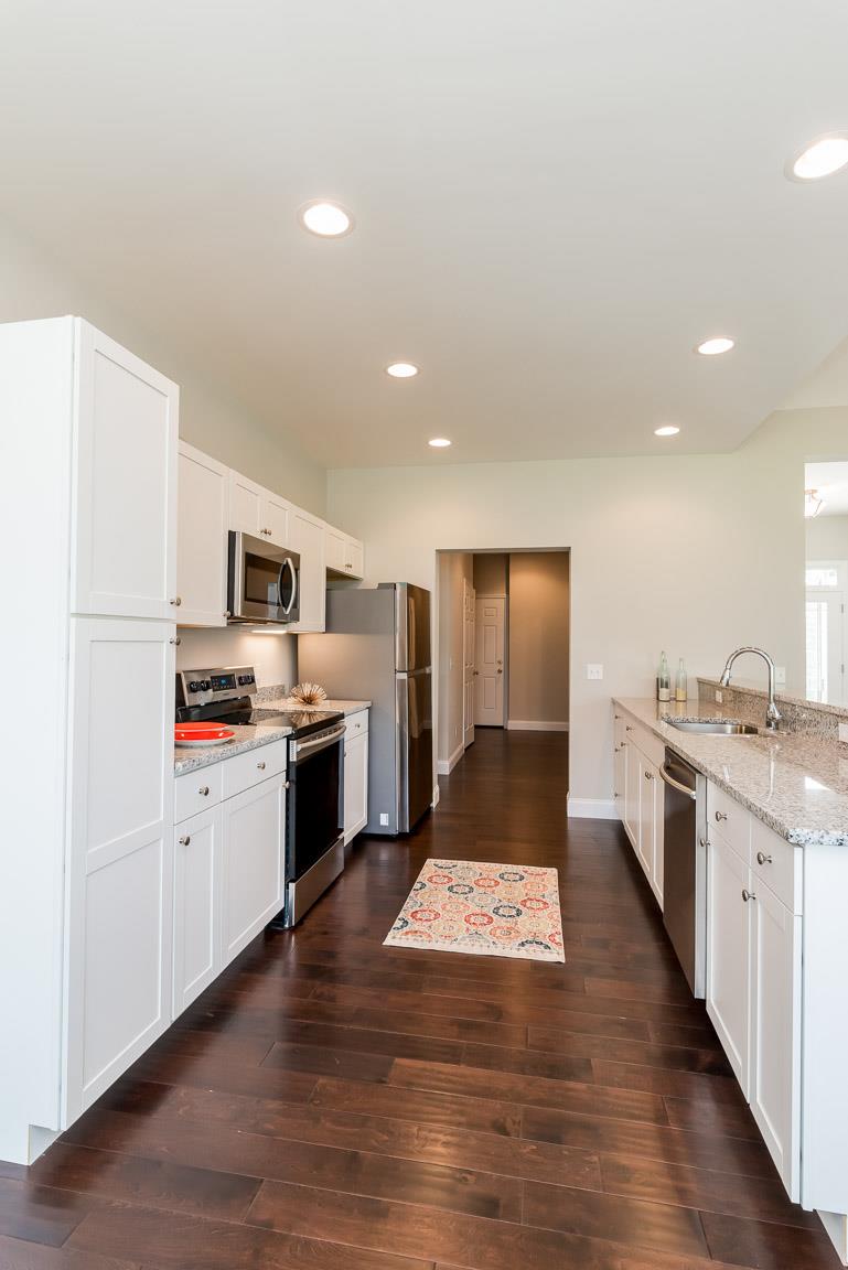 708 Ruby Way White Bluff, TN 37187 - Photo 8 of 30 a large kitchen with a stove top oven and refrigerator