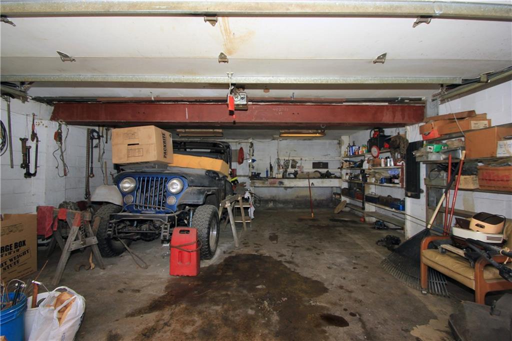 1122 Hamil Road Penn Hills, PA 15147 - Photo 22 of 24 Garage - The oversized two car integral garage has plenty of room for two cars and a lot of additional room for work space or storage. Don't mind the clutter - The sellers family is working on clearing everything out!