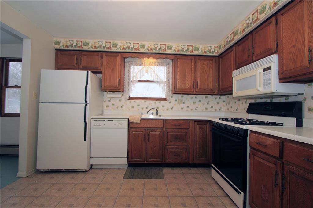 1122 Hamil Road Penn Hills, PA 15147 - Photo 7 of 24 This alternate view of the kitchen provides a good view of the refrigerator, dishwasher, gas stove and microwave. All appliances are included in the sale.