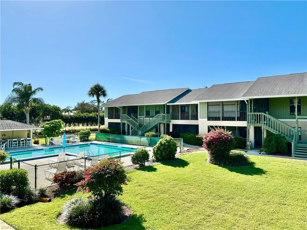 a view of a house with backyard and sitting area