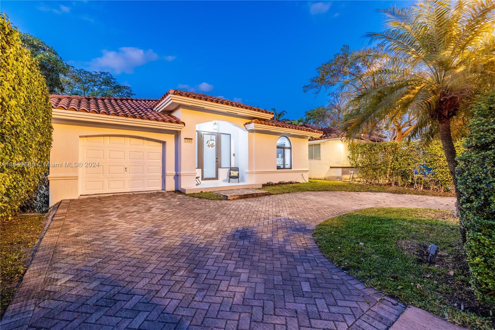 1543 Bird Road Coral Gables, FL 33146 - Photo 1 of 65 a front view of a house with a yard and garage