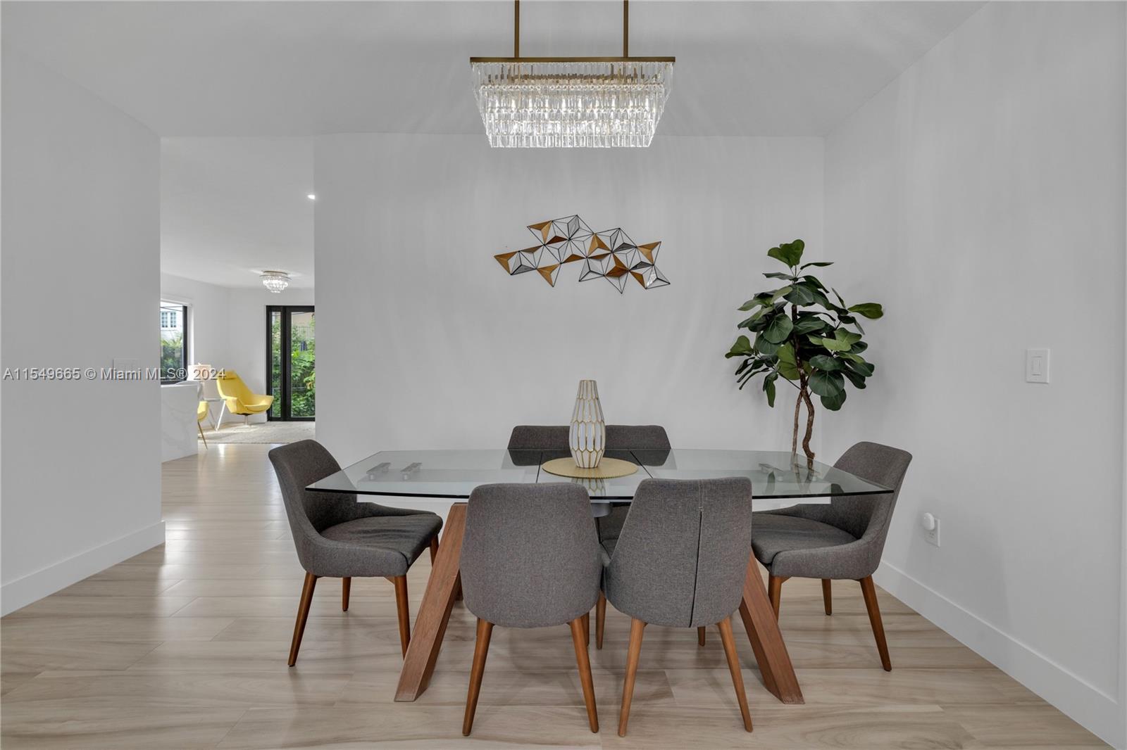 1543 Bird Road Coral Gables, FL 33146 - Photo 16 of 65 a view of a dining room with furniture and a potted plant
