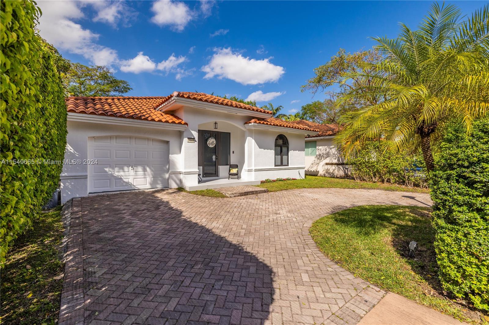 1543 Bird Road Coral Gables, FL 33146 - Photo 2 of 65 a front view of a house with swimming pool and porch