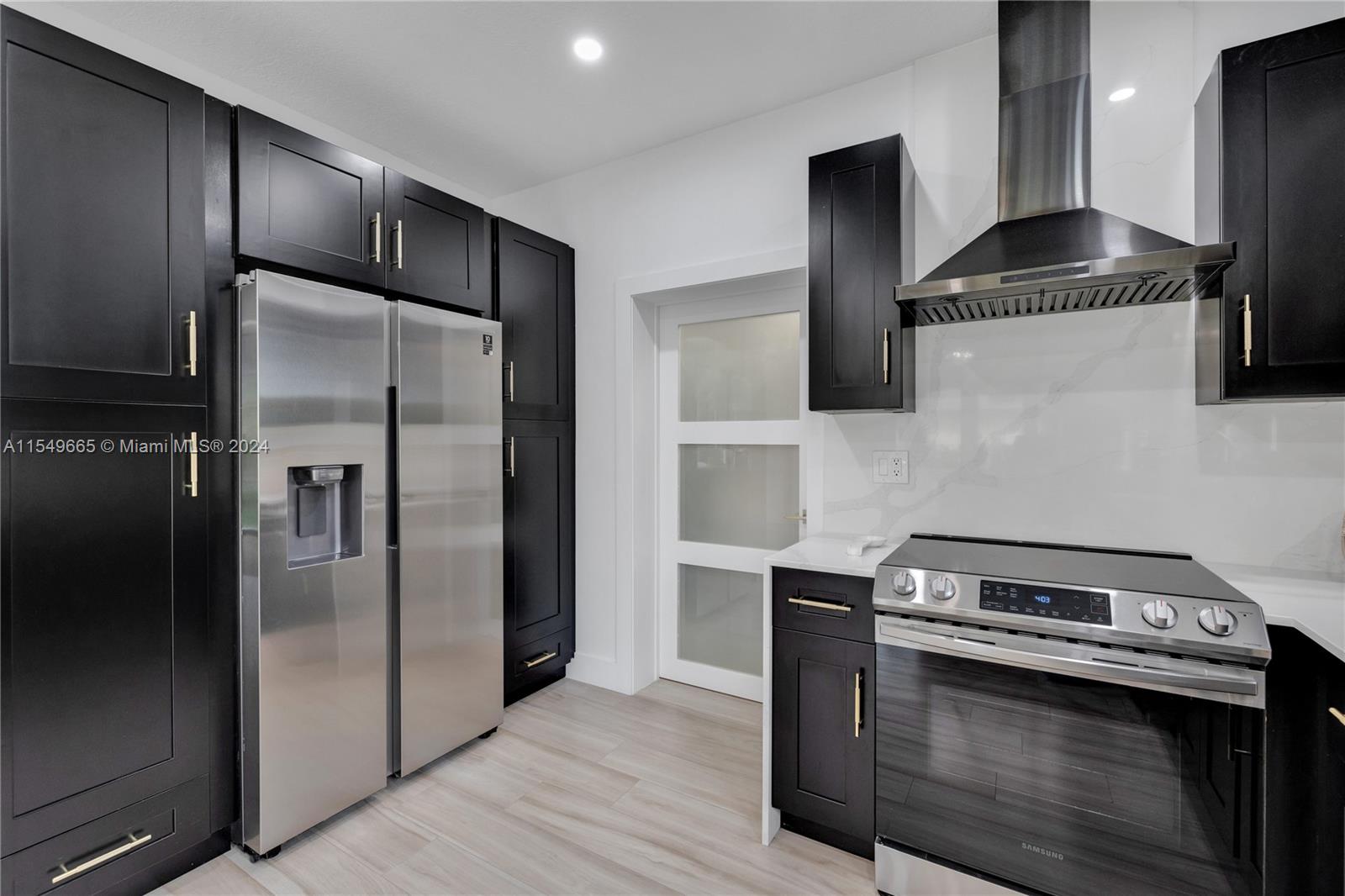 1543 Bird Road Coral Gables, FL 33146 - Photo 22 of 65 a kitchen with stainless steel appliances granite countertop a refrigerator and a stove