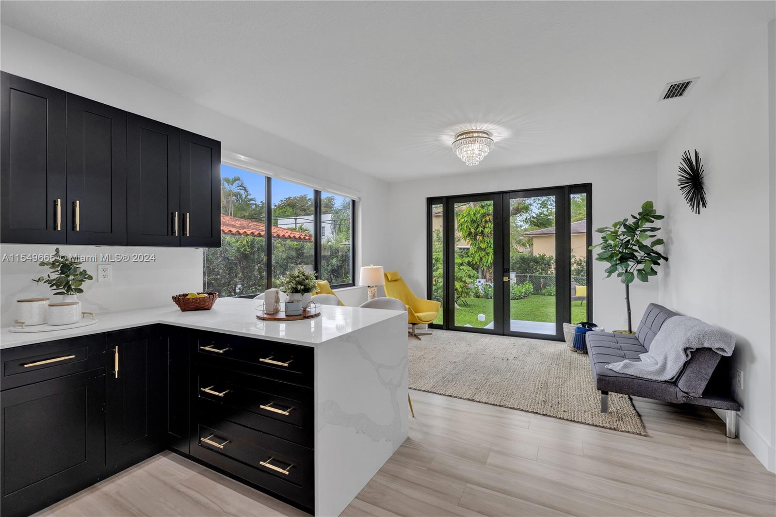 1543 Bird Road Coral Gables, FL 33146 - Photo 24 of 65 a kitchen with a sink cabinets and wooden floor