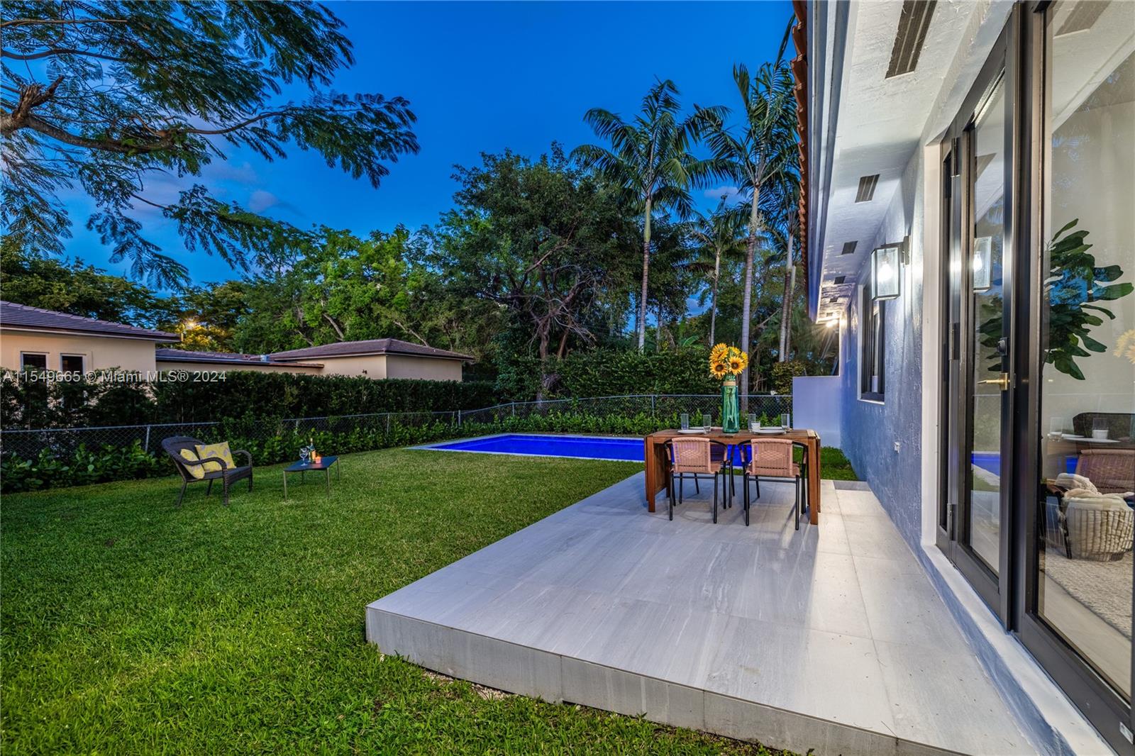 1543 Bird Road Coral Gables, FL 33146 - Photo 26 of 65 a view of a swimming pool with a table and chairs
