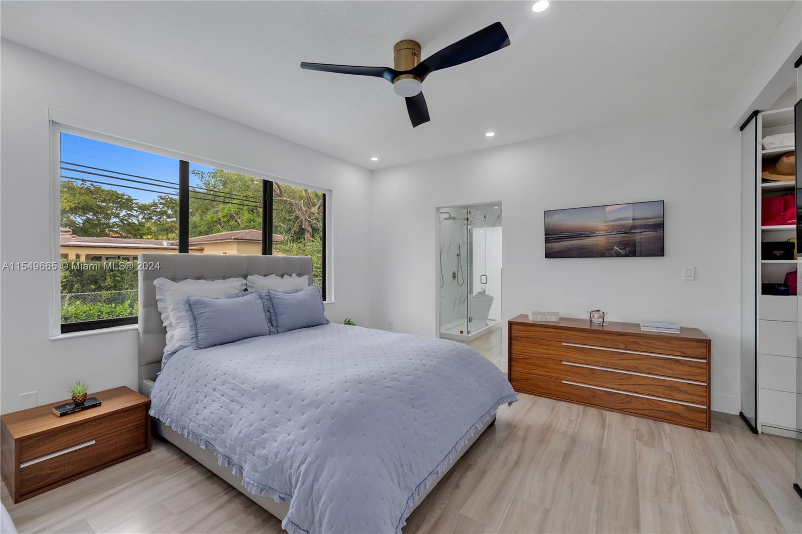 1543 Bird Road Coral Gables, FL 33146 - Photo 28 of 65 a bedroom with a bed a dresser and a large window