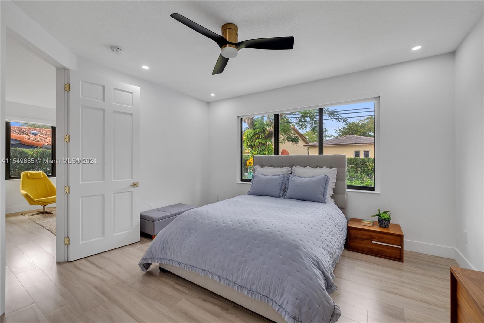1543 Bird Road Coral Gables, FL 33146 - Photo 29 of 65 a bedroom with a bed and wooden floor