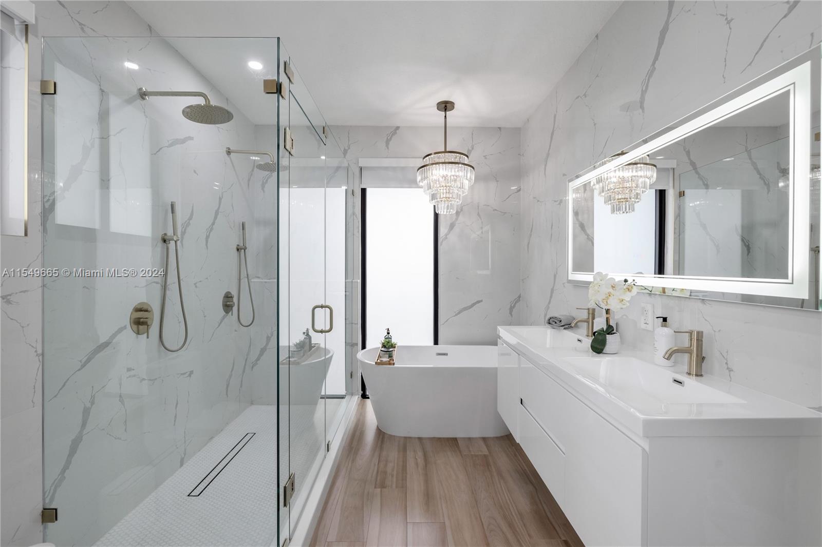 1543 Bird Road Coral Gables, FL 33146 - Photo 30 of 65 a bathroom with a double vanity sink mirror double and shower