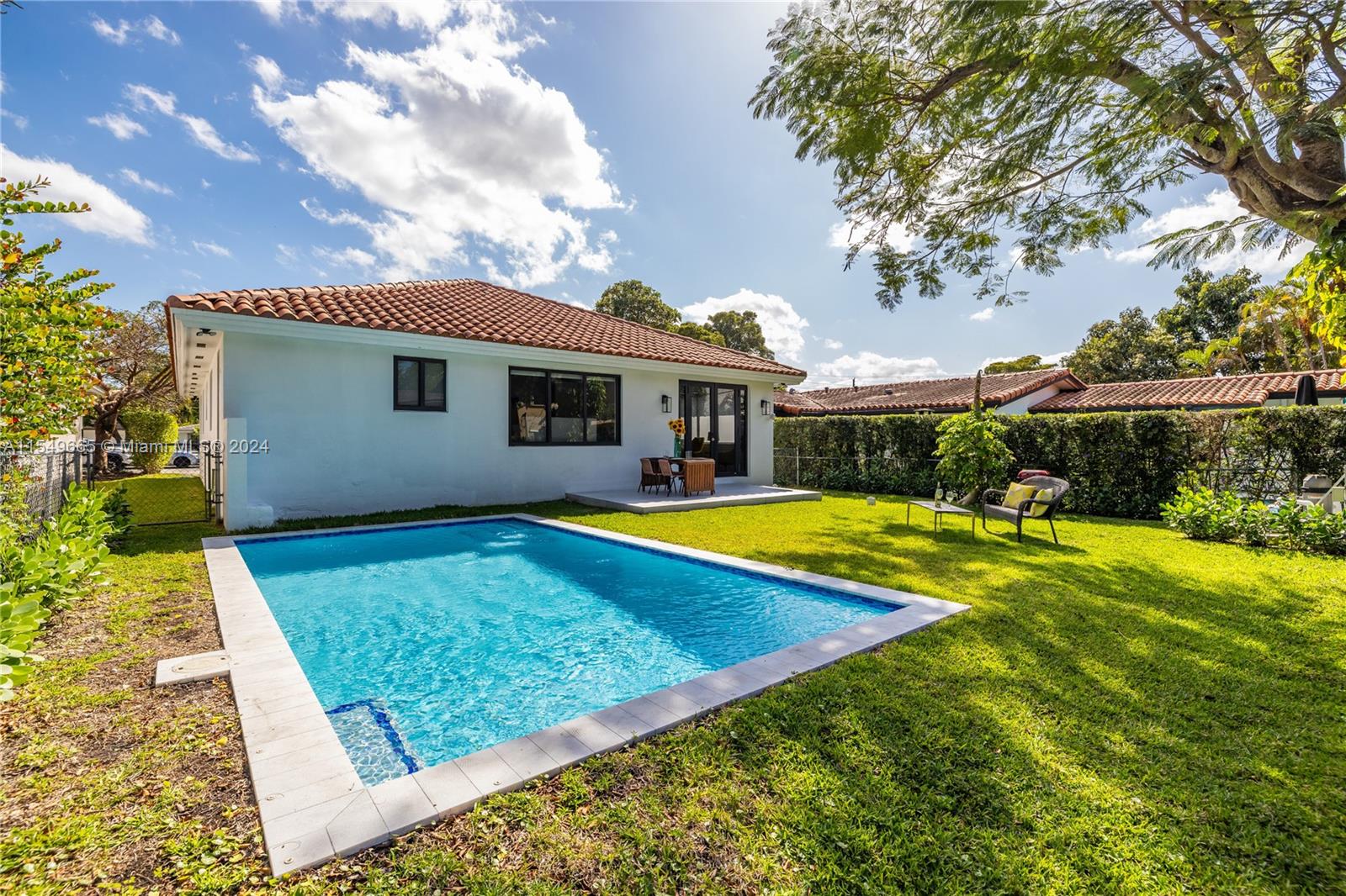 1543 Bird Road Coral Gables, FL 33146 - Photo 3 of 65 a view of house with swimming pool yard and outdoor seating