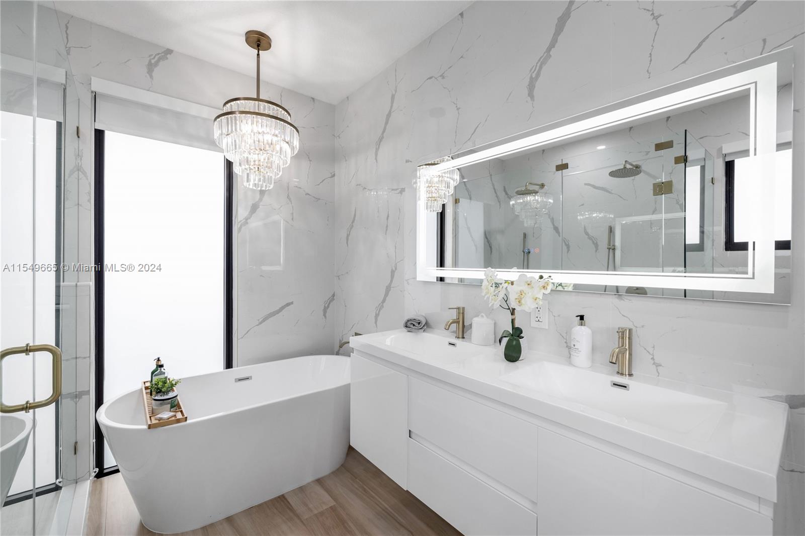 1543 Bird Road Coral Gables, FL 33146 - Photo 31 of 65 a bathroom with a bathtub a sink and mirror