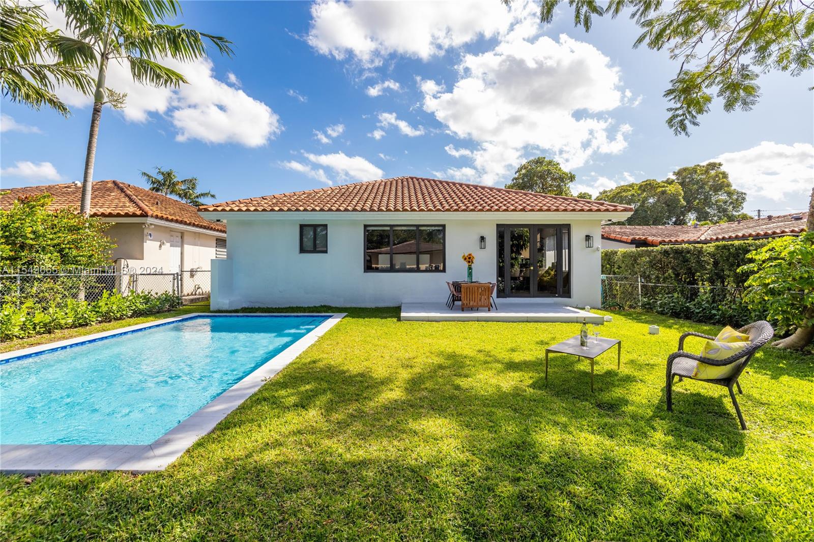 1543 Bird Road Coral Gables, FL 33146 - Photo 34 of 65 a view of a house with swimming pool and sitting area