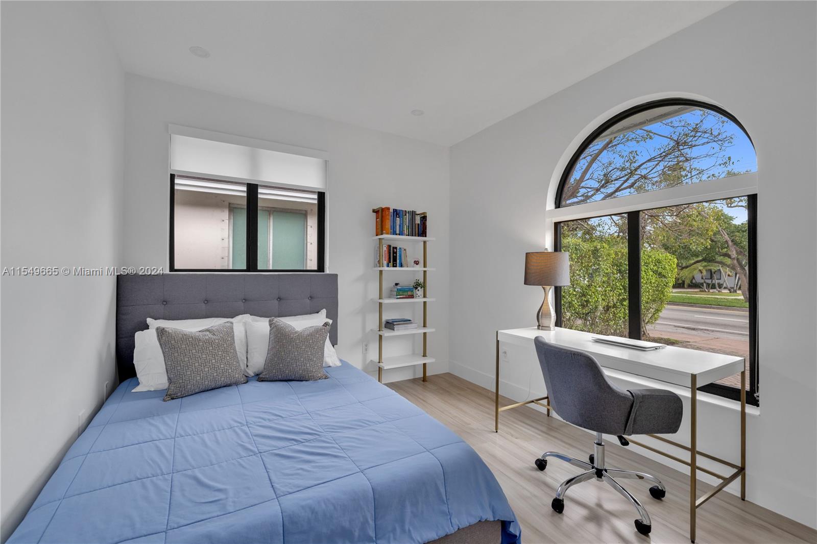 1543 Bird Road Coral Gables, FL 33146 - Photo 39 of 65 a bedroom with a bed a table and painting on the wall
