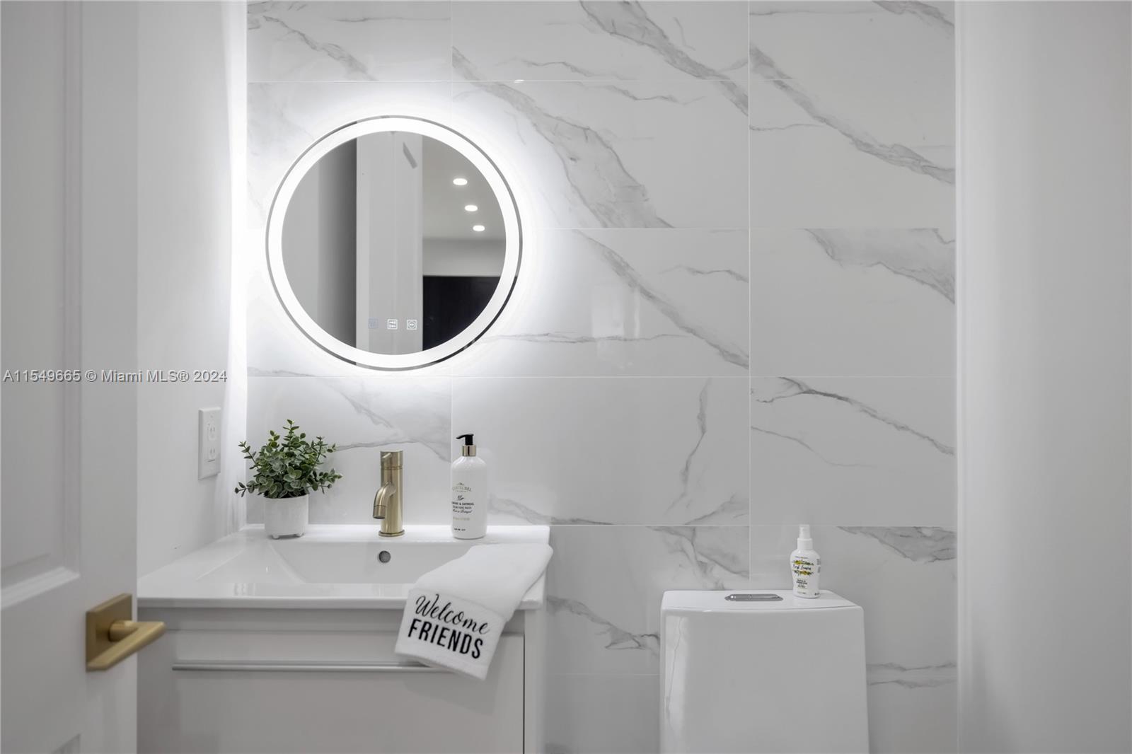 1543 Bird Road Coral Gables, FL 33146 - Photo 40 of 65 a bathroom with a sink and mirror