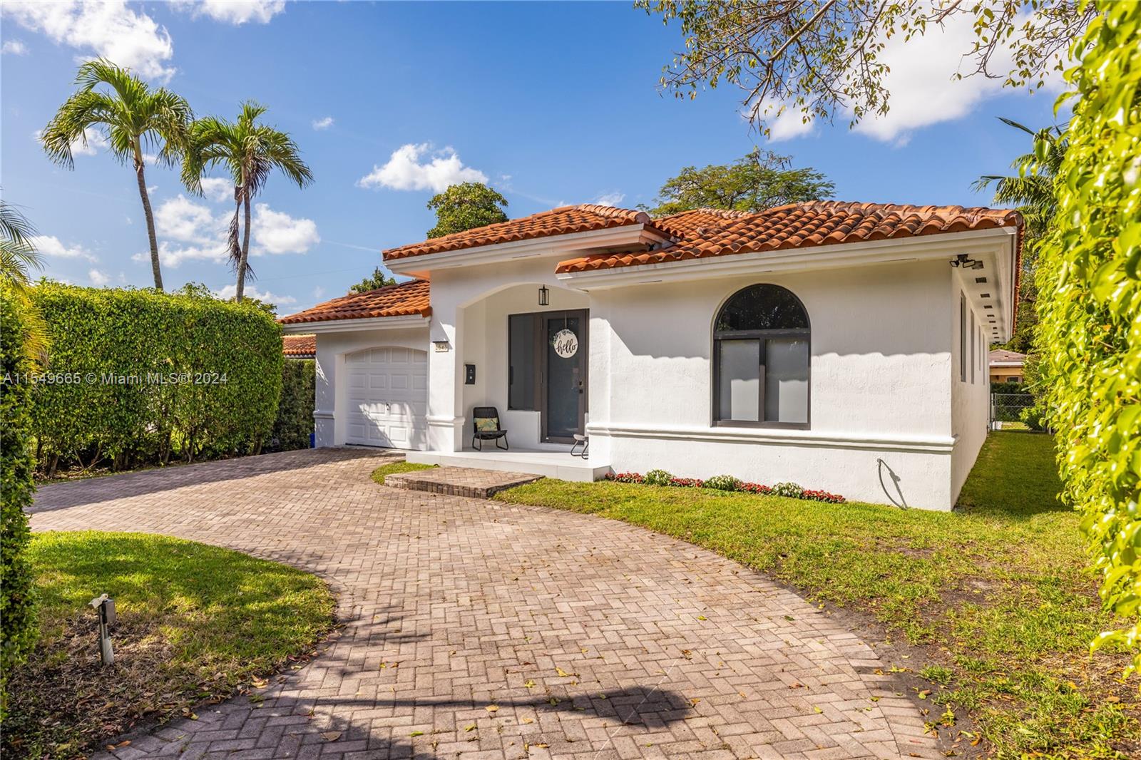 1543 Bird Road Coral Gables, FL 33146 - Photo 43 of 65 a view of a white house with a yard and plants