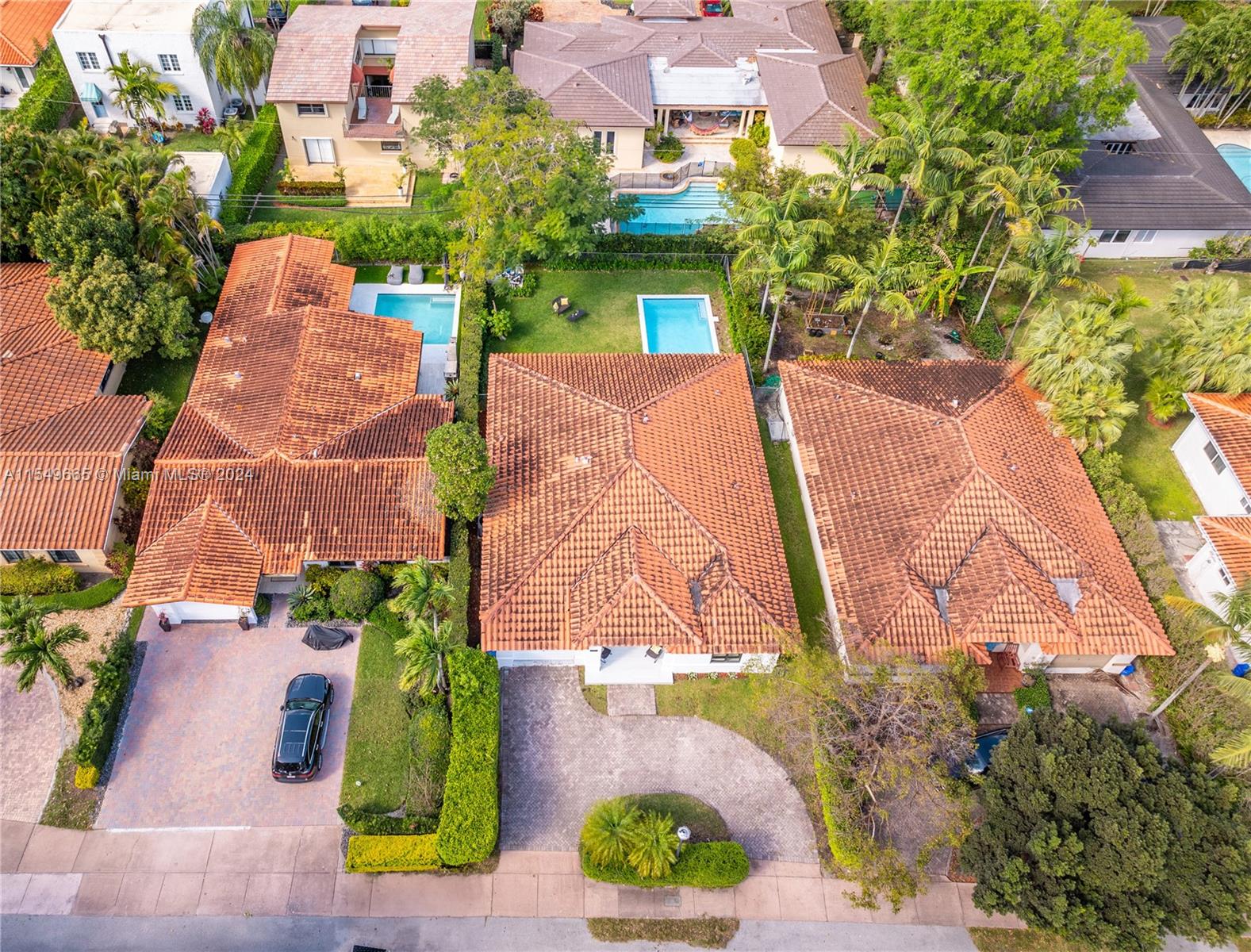 1543 Bird Road Coral Gables, FL 33146 - Photo 52 of 65 an aerial view of multiple houses with yard
