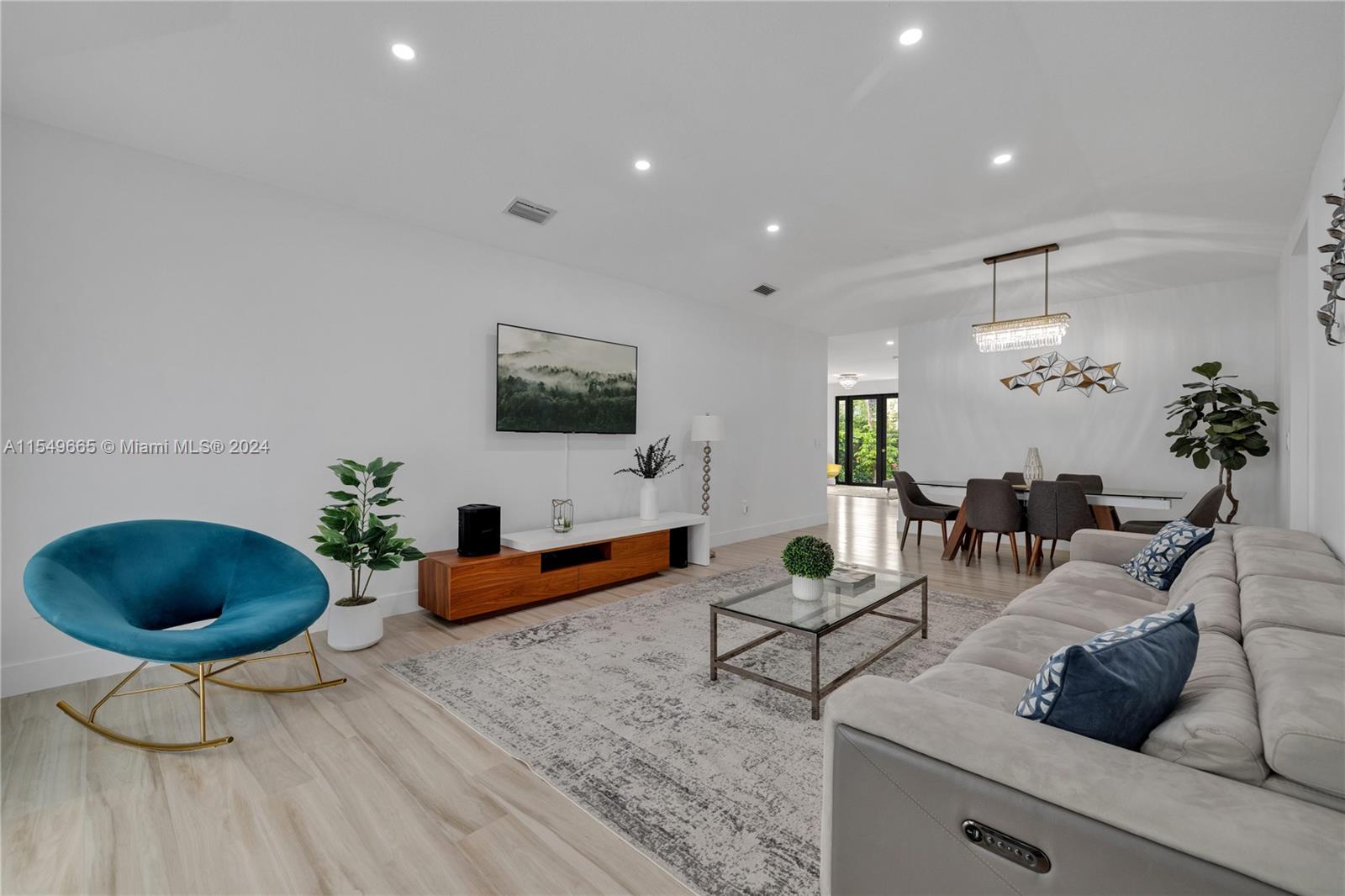 1543 Bird Road Coral Gables, FL 33146 - Photo 10 of 65 a living room with furniture and a flat screen tv
