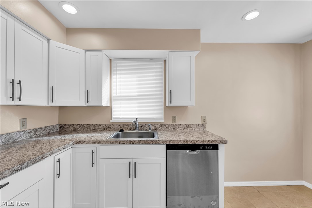 9716 Alexander Road Cleveland, OH 44125 - Photo 7 of 30 Kitchen with dishwasher, white cabinetry, recessed lighting, and light tile patterned flooring