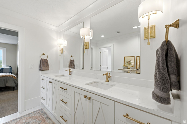 71 Farm Road Midway, UT 84049 - Photo 56 of 92 Dual vanity with white cabinetry, gold-finish hardware, and integrated sinks set into a white countertop