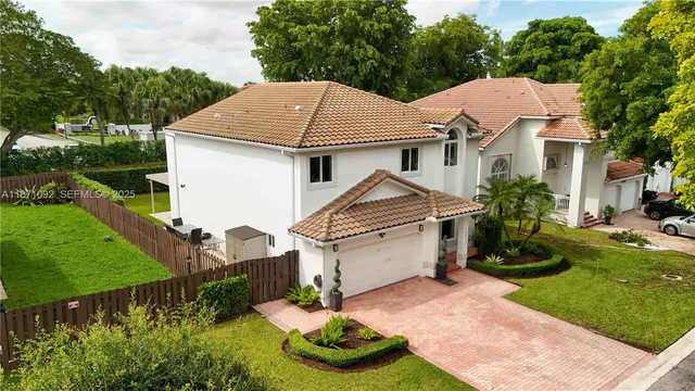 a aerial view of a house with a yard and plants