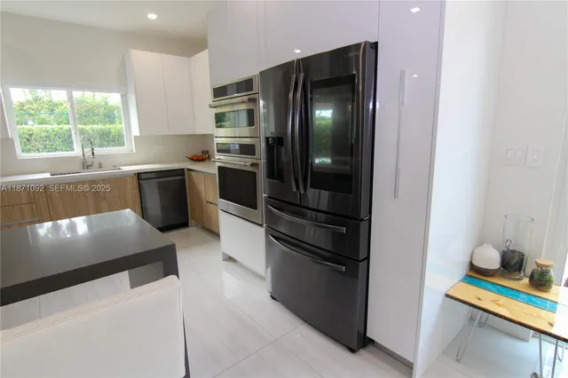 a kitchen with granite countertop stainless steel appliances and counter space