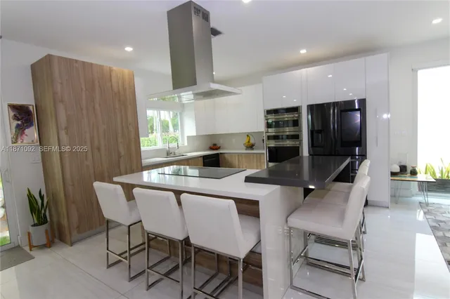 a kitchen with a table chairs refrigerator and microwave