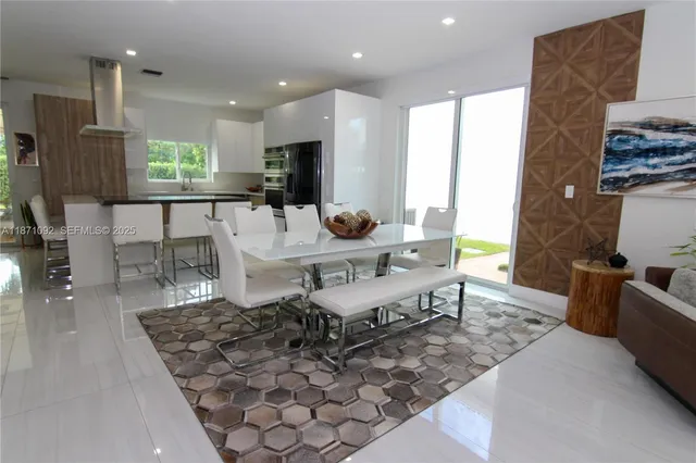 a living room with furniture a flat screen tv and a table