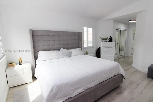 a bedroom with a bed and a couch