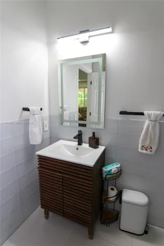 a bathroom with a sink toilet and mirror