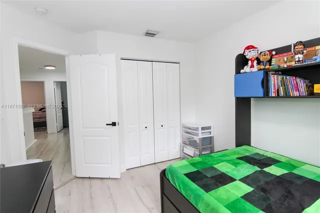 a view of a bedroom with baby bed and toys