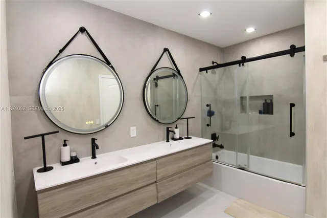 a bathroom with a tub sink and mirror