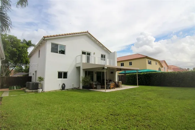 a view of house with yard and entertaining space
