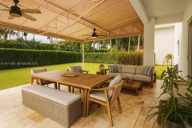 a patio with glass top table and chairs